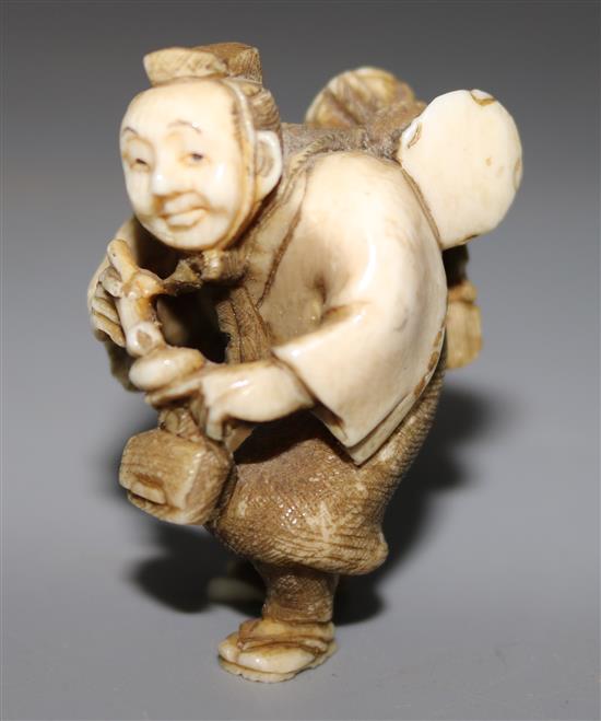 An ivory netsuke of a pipe smoking man